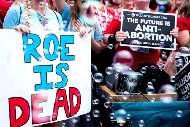 Anti-abortion activists hold signs outside the US Supreme Court after overturning of Roe vs Wade