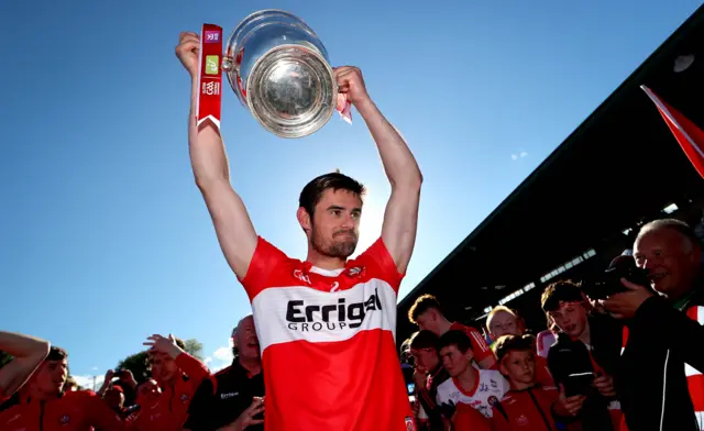 Chrissy McKaigue lifts the Ulster Championship