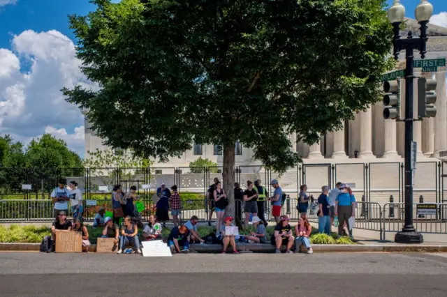 Protesters take a break from the July heat