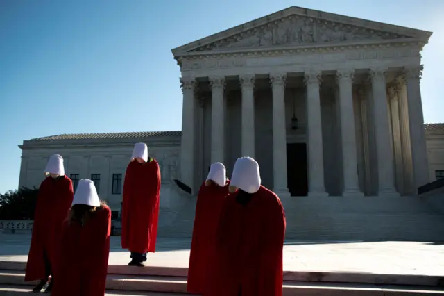 Demonstrators from the Center for Popular Democracy Action stand on the U.S. Supreme Court steps dressed in Handmaids Tale costumes to voice opposition to Judge Amy Coney Barretts nomination to the court on Wednesday, Sept. 30, 2020