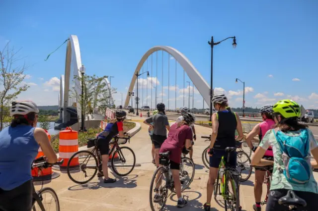 Cyclists gather to look at the protest