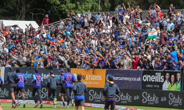 India fans cheer on their team during warm-up for Sunday's game