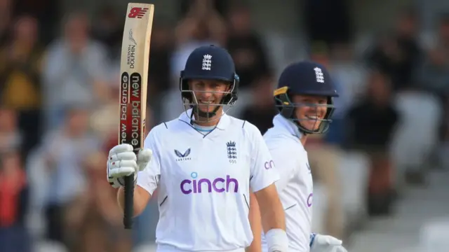 Joe Root celebrating his half century