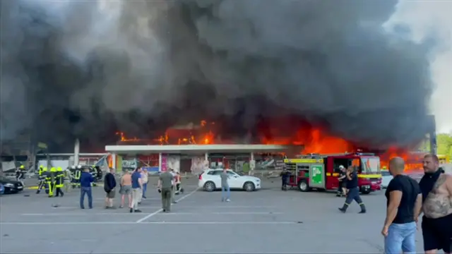 Firefighters tackle the fire at the Kremenchuk shopping centre