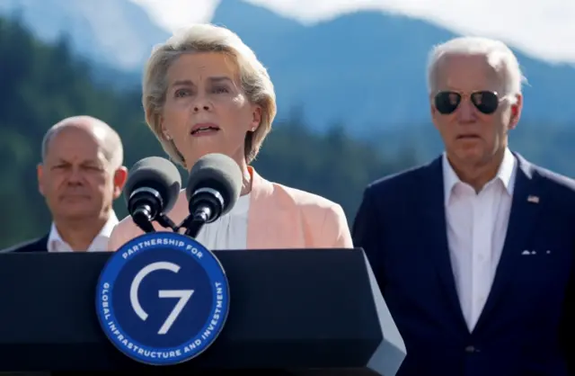 European Commission President Ursula von der Leyen, flanked by Chancellor Scholz and President Biden