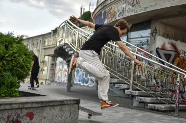 A boy trains on his skateboard in Kyiv