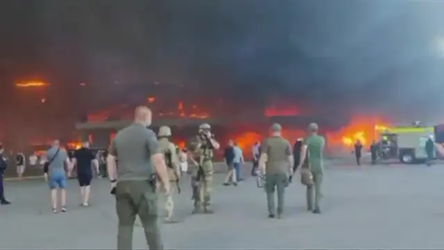 People surround the centre in the aftermath of the Kremenchuk attack