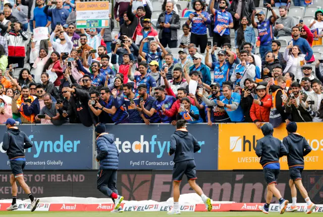 India fans show their support for the team during the warm-up