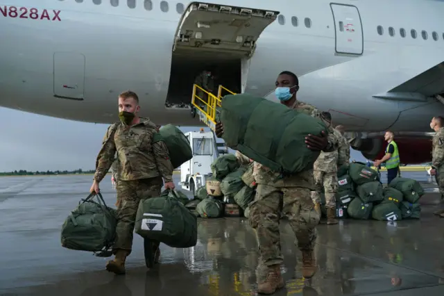 American soldiers unload an aeroplane