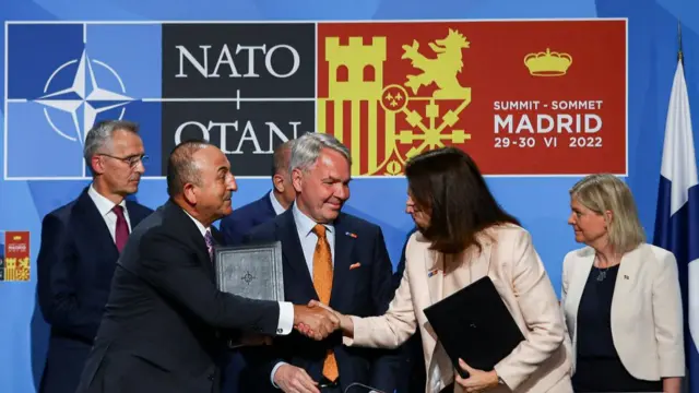 Turkish Foreign Minister Mevlut Cavusoglu shakes hands with Sweden's Foreign Minister Ann Linde after yesterday's talks