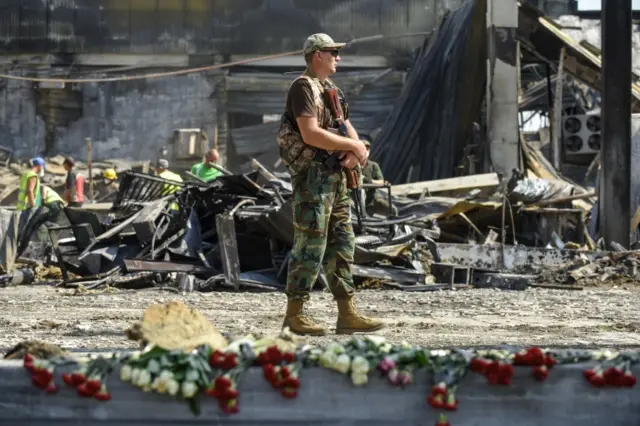 A soldier walks in front of the Kramenchuk shopping mall