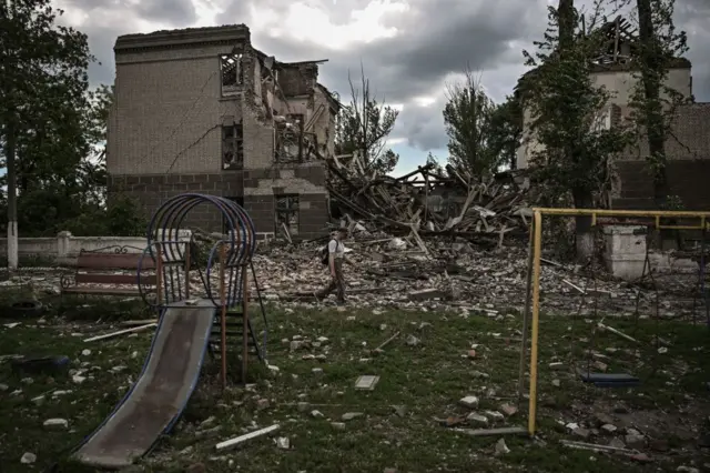 A man walks in front of a destroyed school in Bakhmut, in the Donbas, last week