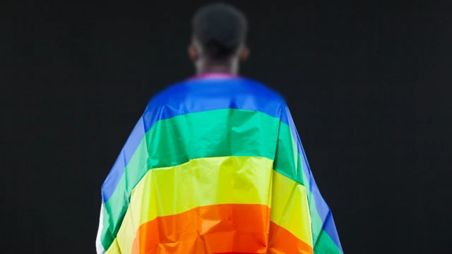 A man draped in a rainbow flag