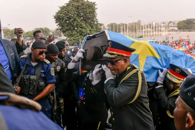 The cortege carrying slain Congolese independence hero Patrice Lumumba's only surviving remains arrives at Palais du Peuple in Kinshasa