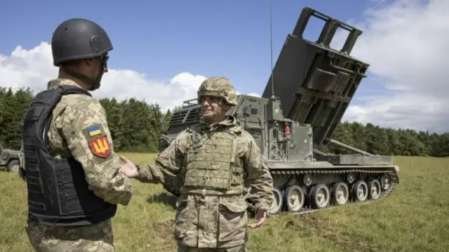 British Army personnel teach members of the Ukrainian armed forces how to operate a multiple-launch rocket systems (MLRS) - to defend itself against Russia - on Salisbury Plain, Wiltshire.