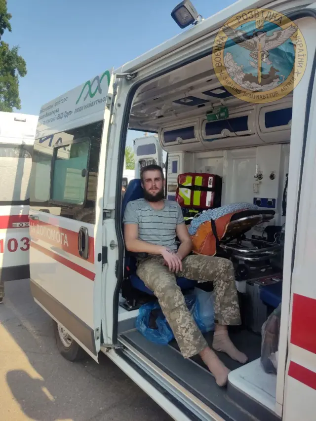 A Ukrainian soldier sits in an ambulance as Ukraine carries out an exchange of prisoners