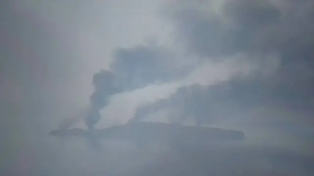 A view of Snake Island with smoke billowing from it in several places