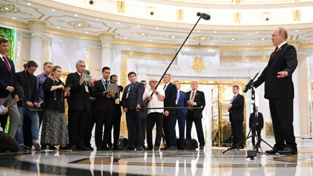 Vladimir Putin speaks to a group of journalists