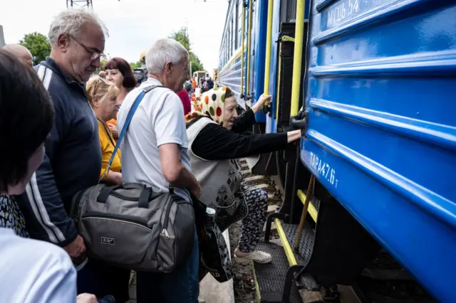 Lysychansk residents boarding a train out of the city