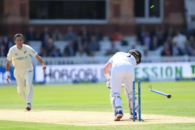 Ollie Pope (right) is bowled by Trent Boult (left)