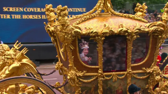 Images from the Queen's coronation appear on the gold State Coach