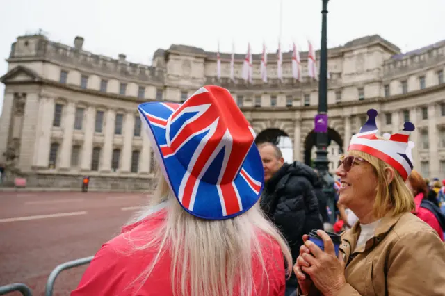 A woman wearing a union flag hat in front of the Mall