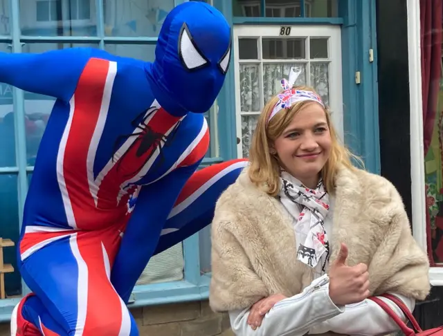 A man wearing a superhero union flag costume