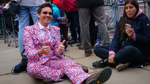 A man wearing a suit covered with a union flag pattern