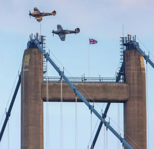 Spitfire and Hurricane along with the flag between the South bank towers.