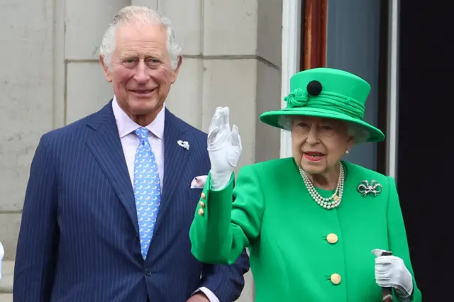 Queen waves alongside Prince Charles