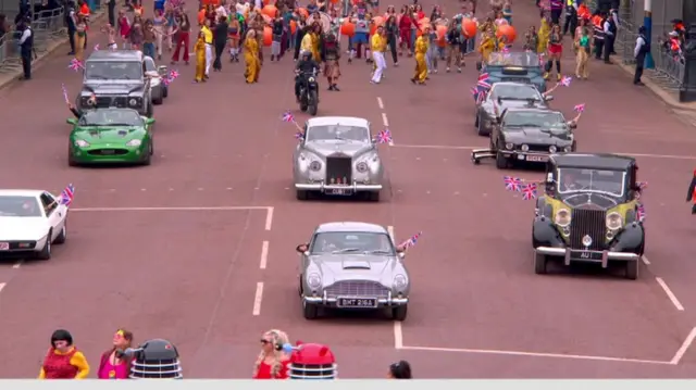 Classic James Bond cars drive down the Mall