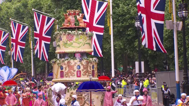 A huge Bollywood-inspired cake surrounded by dancers wearing Saris