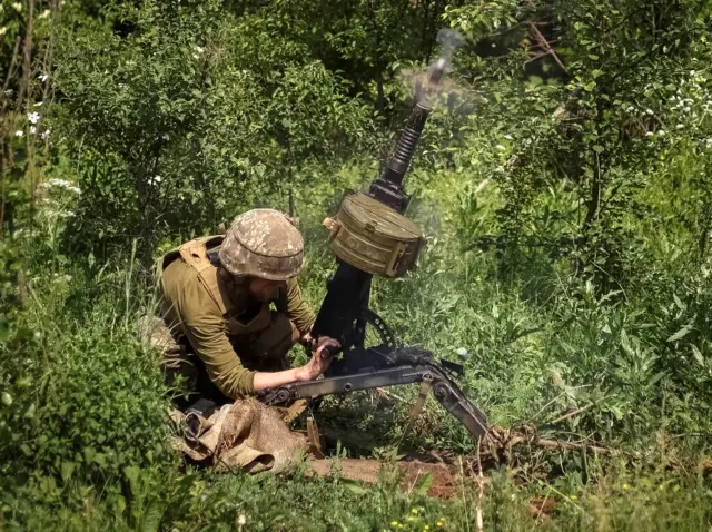A Ukrainian soldier shoots from an automatic grenade launcher
