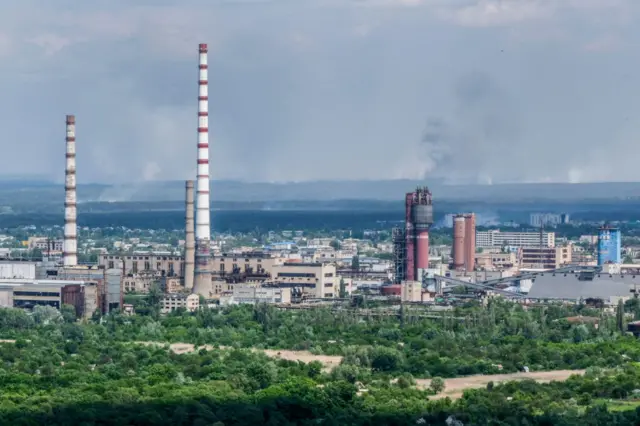 View of factory chimneys and rooftops across Severodonetsk