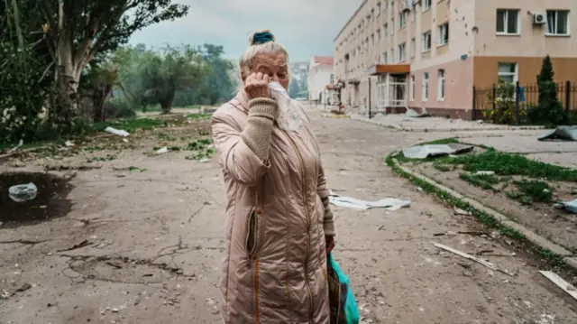 A woman in Lysychansk, in the Luhansk region, is pictured sobbing