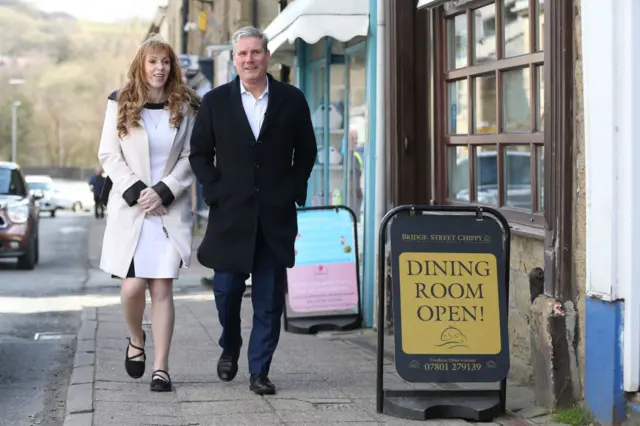 Labour's deputy leader Angela Rayner and leader Sir Keir Starmer walk down a street in Ramsbottom