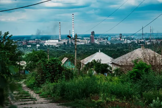Severodonestk cityscape with smoke rising in some areas
