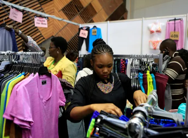 A woman browses clothes.