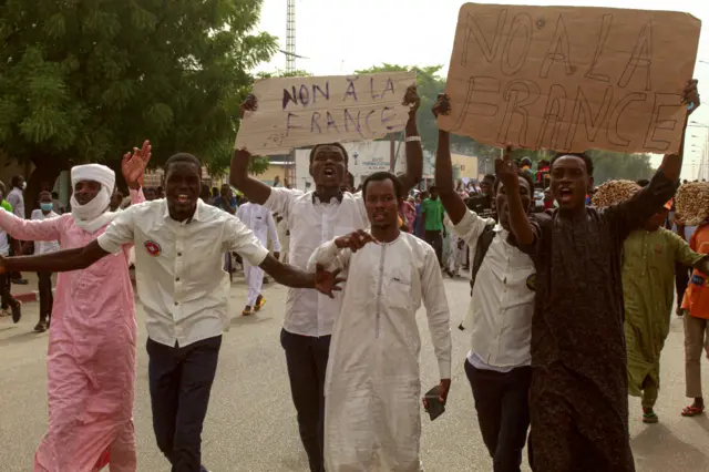 Demonstrators carry placards which read as 'No to France' as they take part in an anti-French protest in N'Djamena on May 14, 2022.