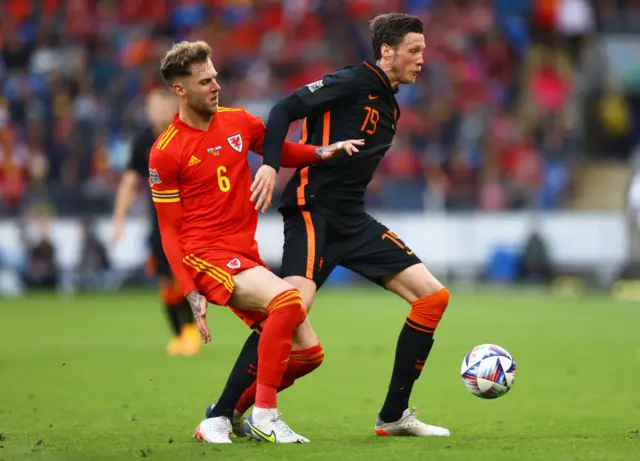 Joe Rodon of Wales battles for possession with Wout Weghorst