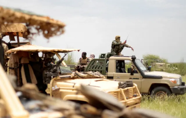 Malian soldiers patrol with soldiers from the new Takuba force near Niger borde