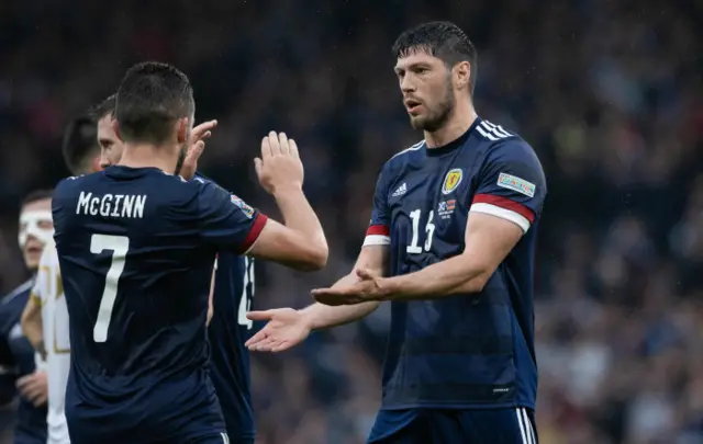 Scott McKenna celebrates his John McGinn after heading Scotland 2-0 up