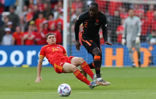 Dan James of Wales is tackled by Jordan Teze