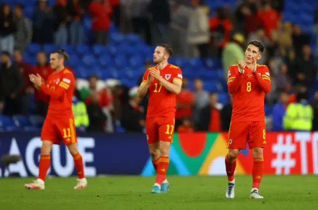 Wales players clap the fans at full time