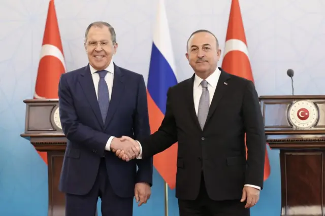 Turkish Foreign Minister Mevlut Cavusoglu, right, and Russian Foreign Minister Sergey Lavrov shake hands