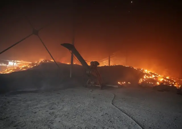 Seeds burn in a grain silo after it was shelled, amid Russia's invasion of Ukraine