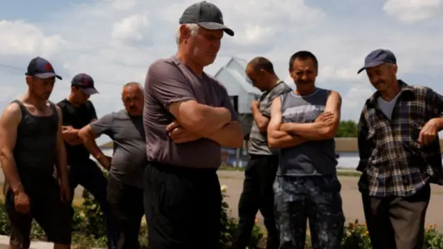 Wheat farmers talk to journalists at a farm outside Bashtanka in the Mykolaiv region