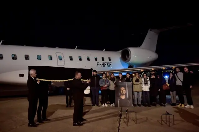 The coffin of French journalist Frederic Leclerc-Imhoff is carried from a plane at Le Bourget Airport