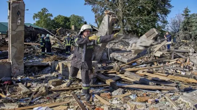 Ukrainian rescuers clear debris following shelling in Kharkiv