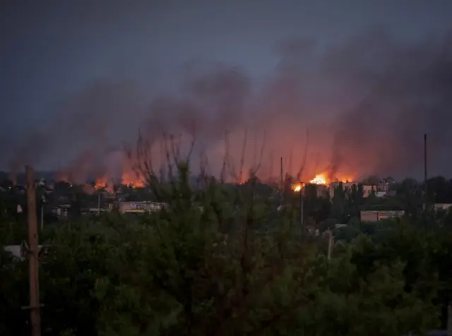 Houses burn after shelling in the town of Marinka, Donetsk region